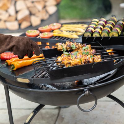 chicken and veg cooking on a fire pit