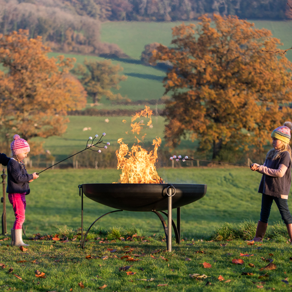 Girls around Plain Jane 120 Fire Pit with Marshmallow Forks at Trostrey - Firepits UK - LoRes02 600x600