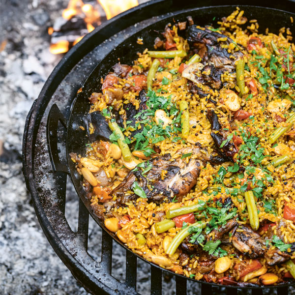 Rabbit for Paella on Swing Arm in Cooking Bowl from Genevieve Taylor's Seared - Firepits UK - LoRes 600x600 1