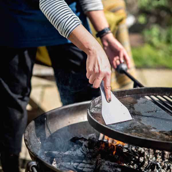 Grill Scraper Flat in Use on Swing Arm - Lifestyle - Firepits UK - PP23 - LoRes254