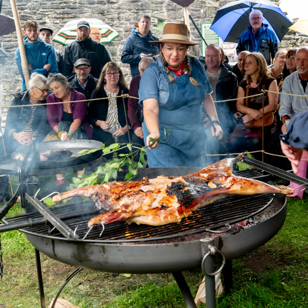 Lamb on Asado Cross on fire pit grill
