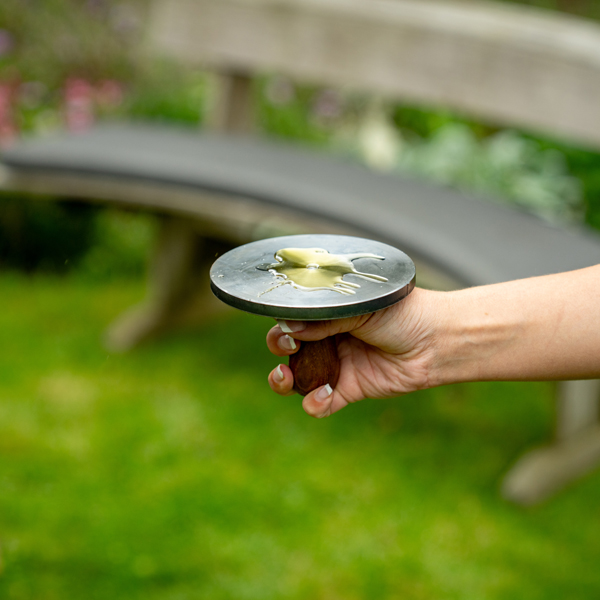 Burger Press with Oil in hand - Firepits UK - Lifestyle - LoRes600x600